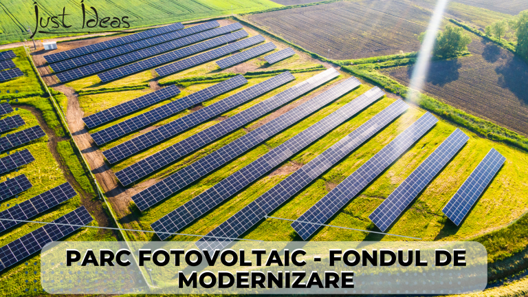Imaginea prezintă un parc fotovoltaic din zona rurală, cu rânduri de panouri solare care captă energia soarelui și o transformă în electricitate. Aceste panouri sunt amplasate pe o suprafață întinsă și sunt îndreptate spre soare. Imaginea surprinde o perspectivă panoramică asupra întregului parc și a împrejurimilor sale, cu munți în depărtare și câmpuri cultivate în apropiere. Este o imagine impresionantă a tehnologiei solare moderne și a eforturilor de a produce energie curată și sustenabilă